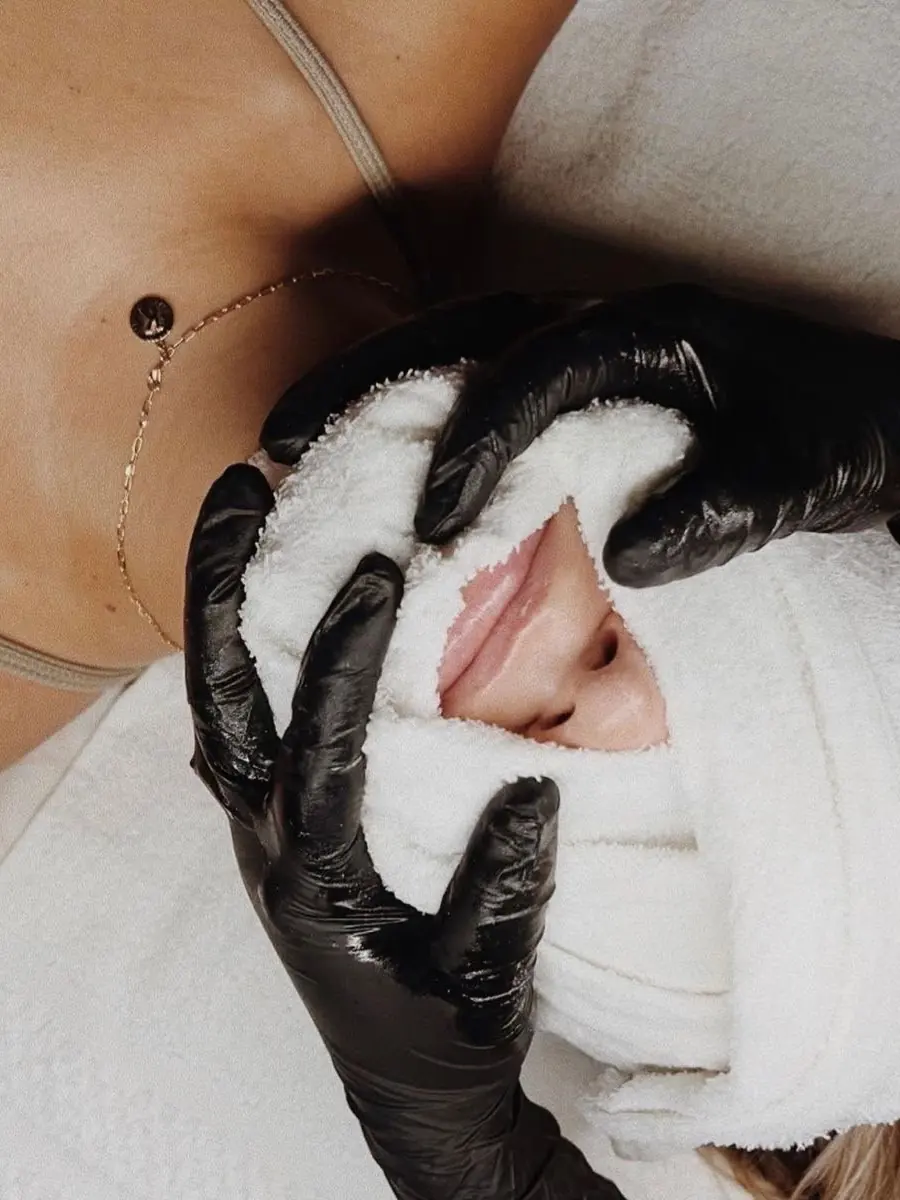 A warm towel cleanse during a facial at Skin9 Studio in Oakville